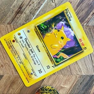 1999 Base Set Pikachu RARE Yellow Cheeks PSA #58. Shadows background.